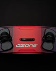 The top of the red Ozone Code v3 kitesurfing board with straps.