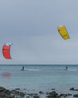 Two kitesurfers riding the Ozone Catalyst V3. One Red and one Yellow.