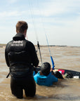 Private kitesurfing lesson in action as the instructor follows the student through the water as they attempt a board start.