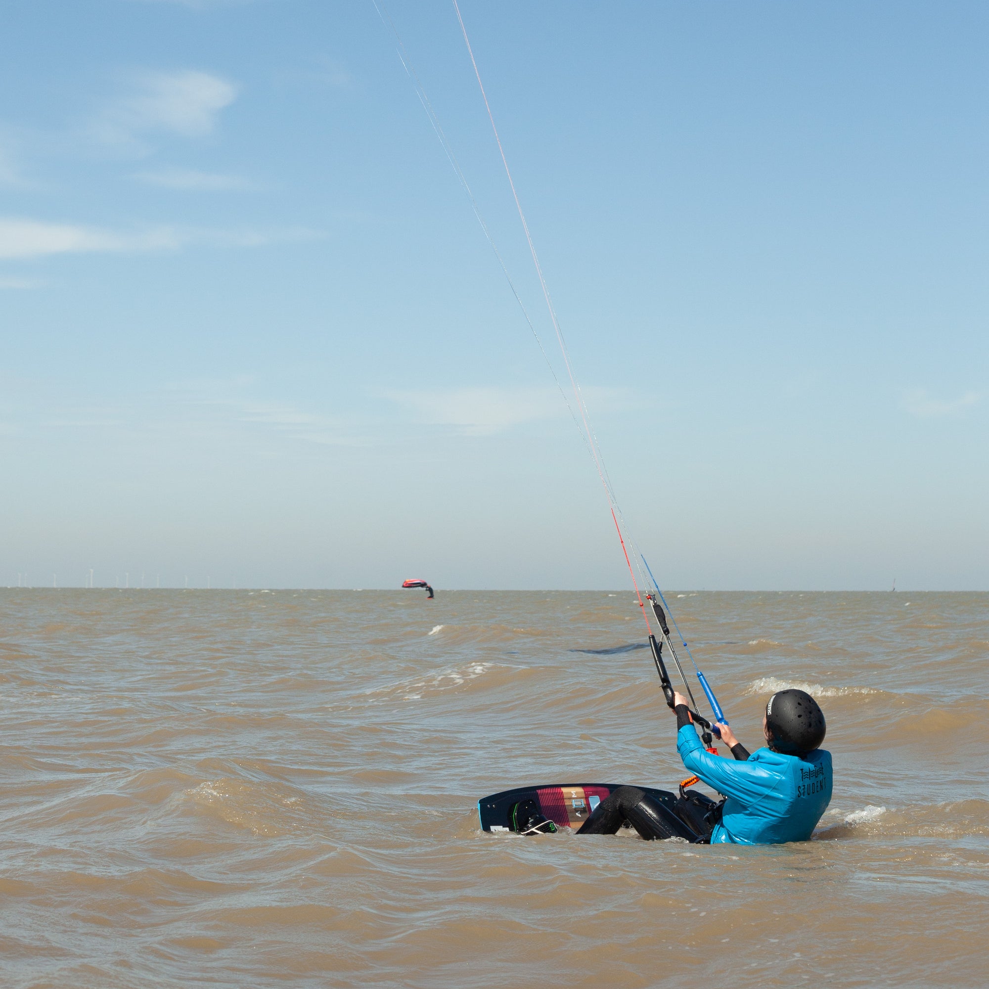 A Tide Watersports student on a private kitesurfing lesson in Margate, Kent in the water about to do a board start.