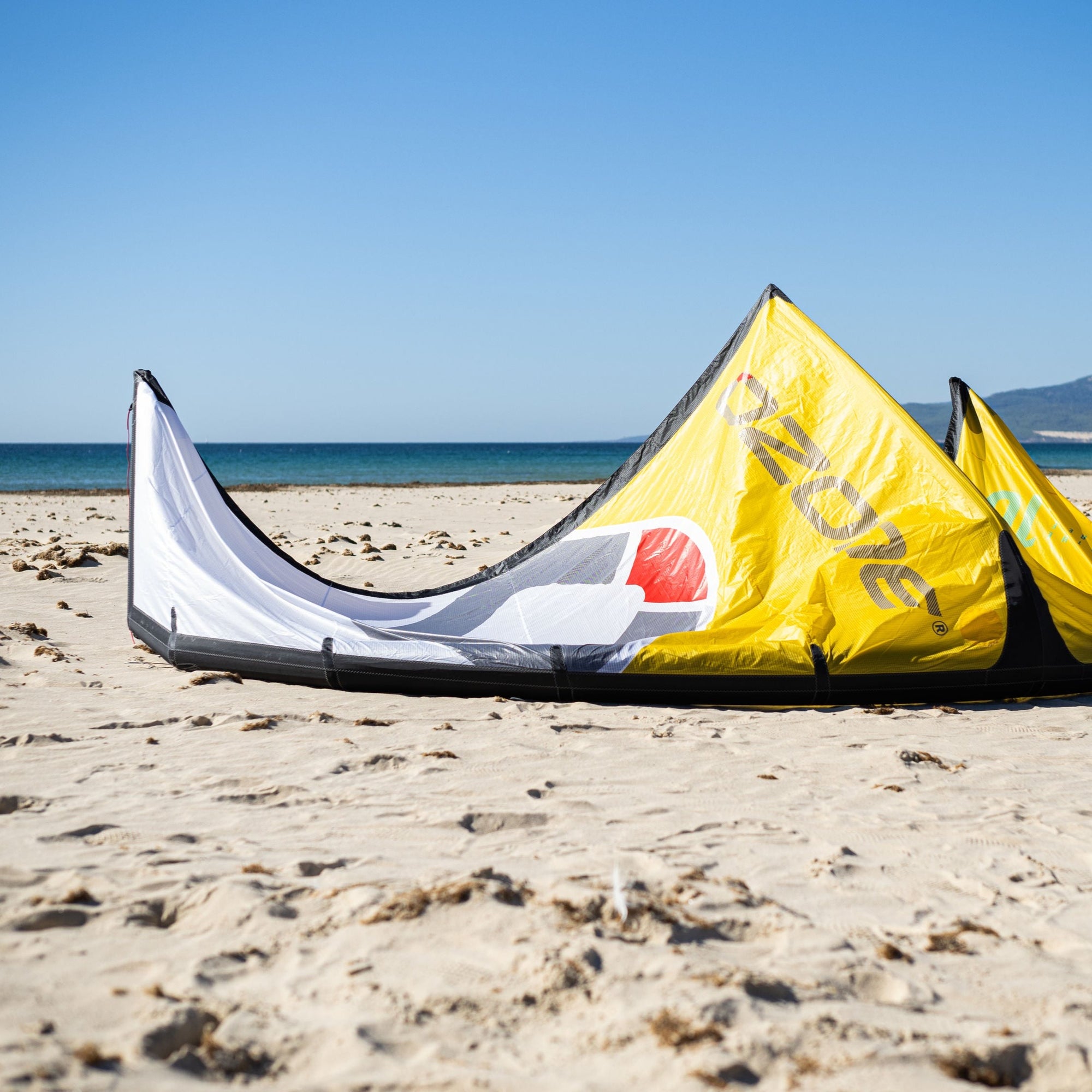 The Ozone Catalyst V3 on Yellow laying on a golden sand beach.