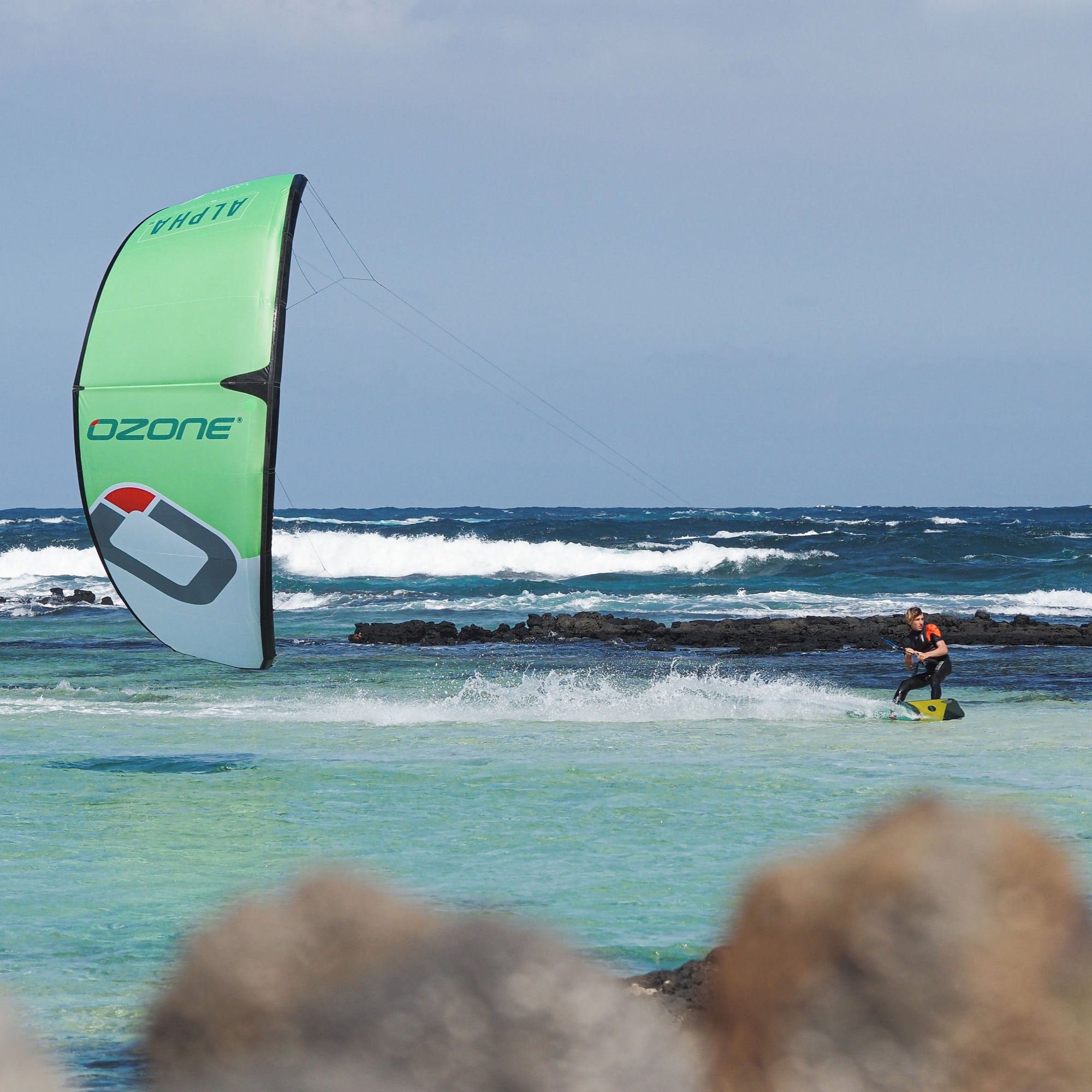 Green Alpha V2 flying low in turquoise water